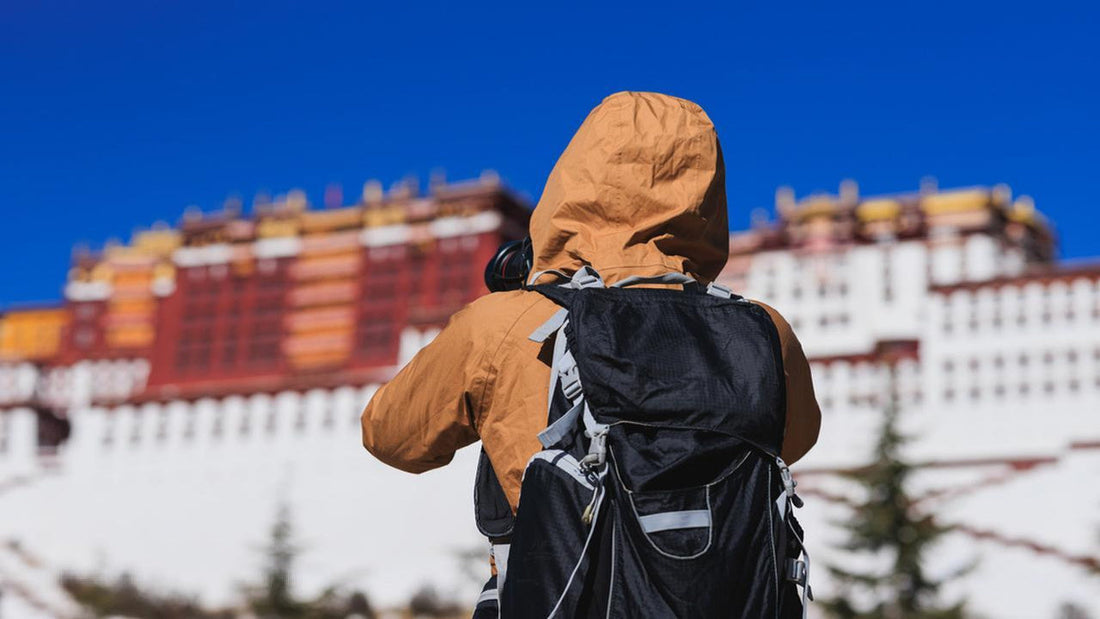 photographer takes a picture of the polata palace during a holiday pacakge to tibet